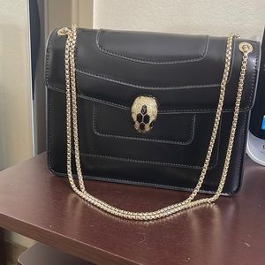 Woman shoulder back black color with gold hardware worn couple times looks new!!